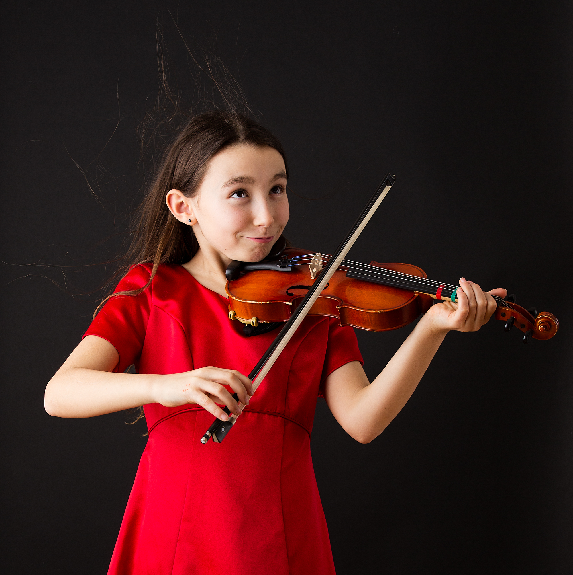 girl in a red dress with a violin