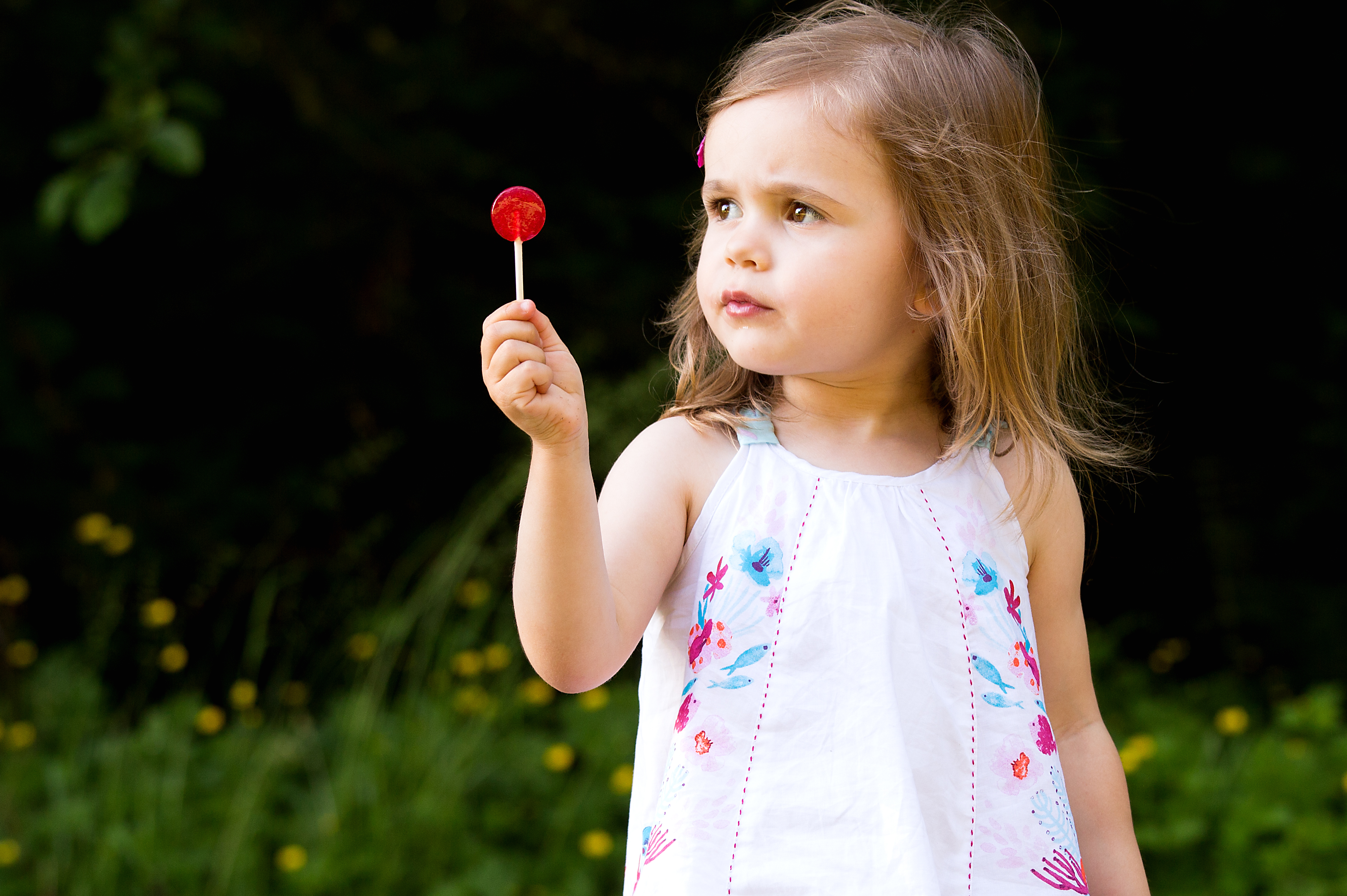 todler girl with a red lollipop